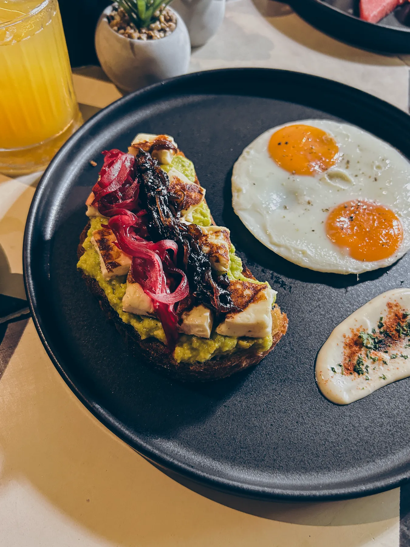 Desayuno de tostada de aguacate con huevos y jugo de naranja en Mood Matuna Hotel